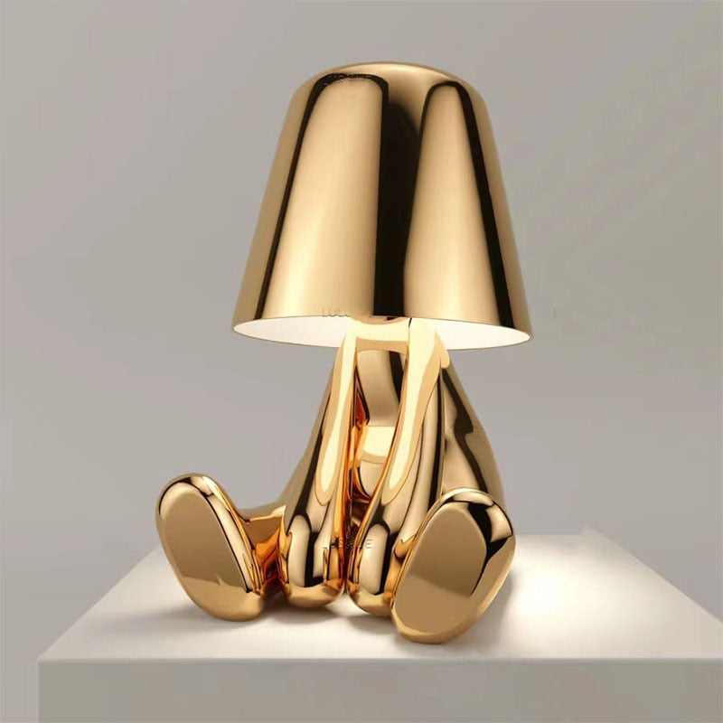 Metallic table light with reflective artistic form